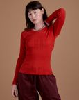Alex is 5’8” and wearing XP Gingham Long Sleeve Baby Tee in Mustang Red