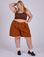 Juliet is 5’7” and wearing 2XL Pleated Trouser Shorts in Burnt Terracotta paired with fudgesicel brown Mini Tank