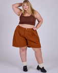 Juliet is 5’7” and wearing 2XL Pleated Trouser Shorts in Burnt Terracotta paired with fudgesicel brown Mini Tank