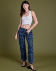Alex is 5’8” and wearing XS Mid-Rise Carpenter Jeans in Lazy Daisy paired with a vintage tee white Cropped Tank