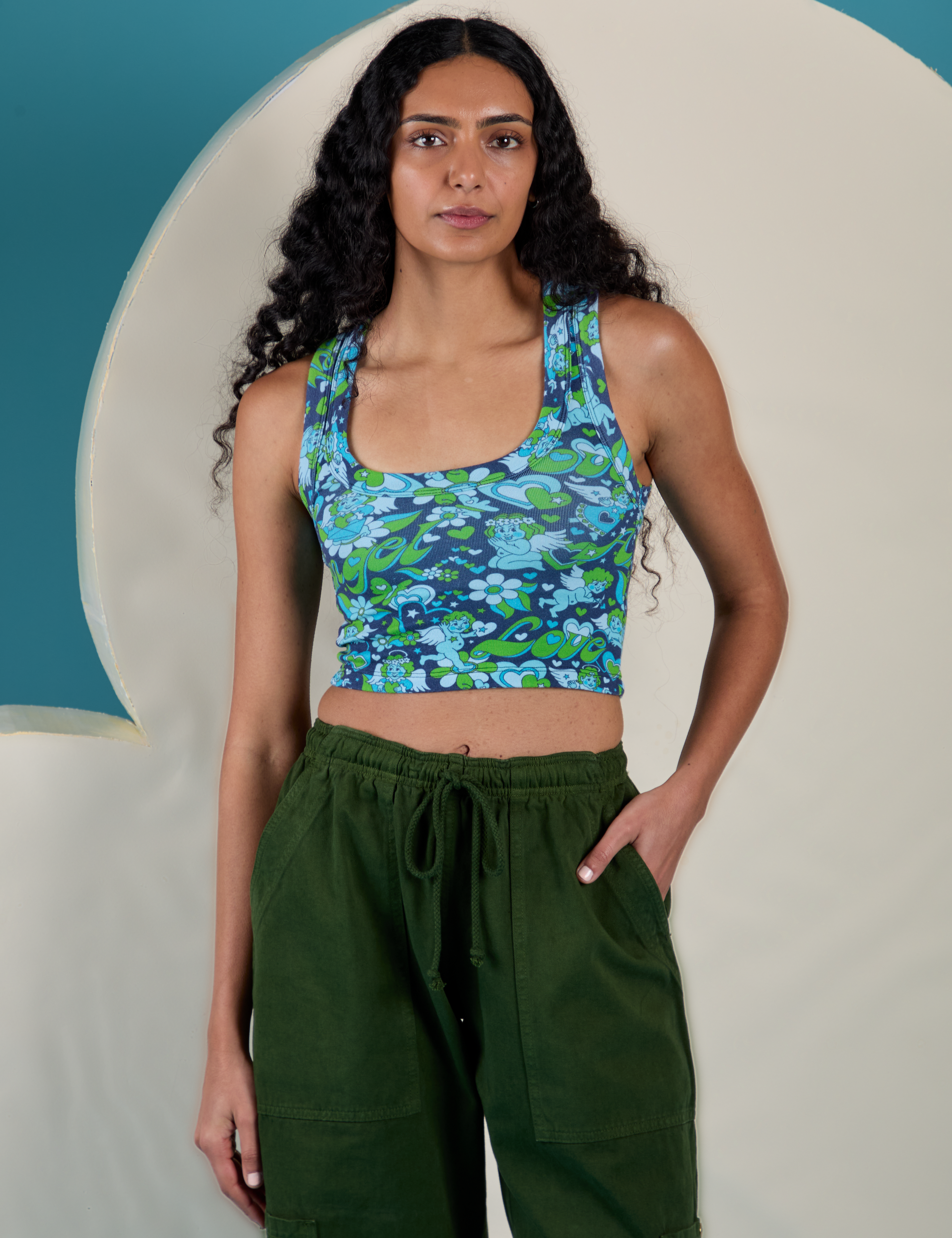 Shahana is 5’10 and wearing P Cropped Tank Top in Angel Print