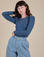 Alex is 5’8” and wearing P Long Sleeve Baby Tee in French Blue