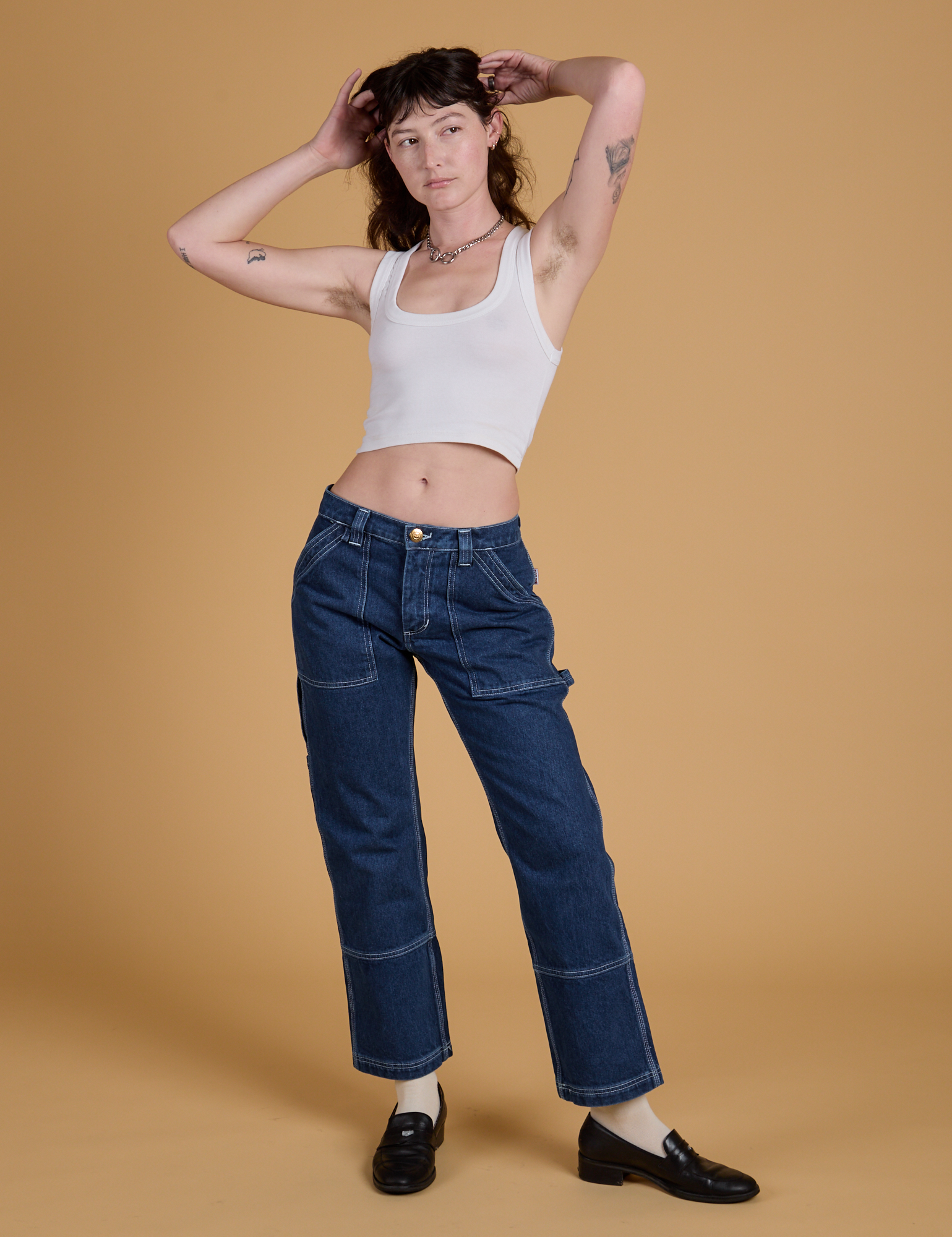 Alex is 5’8” and wearing XS Mid-Rise Carpenter Jeans in Dark Wash