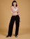 Alex is 5'8" and wearing XXS Baggy Mid-Rise Trousers in Basic Black paired with a vintage tee white Cropped Tank