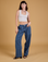 Alex is 5'8" and wearing XXS Baggy Mid-Rise Trousers in French Blue paired with a vintage tee white Cropped Tank