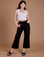Alex is 5'8" and wearing XXS Organic Action Pants in Basic Black paired with a vintage tee white Cropped Tank