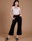 Alex is 5'8" and wearing XXS Organic Action Pants in Basic Black paired with a vintage tee white Cropped Tank