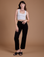 Alex is 5'8" and wearing XXS Organic Work Pants in Basic Black paired with a vintage tee white Cropped Tank