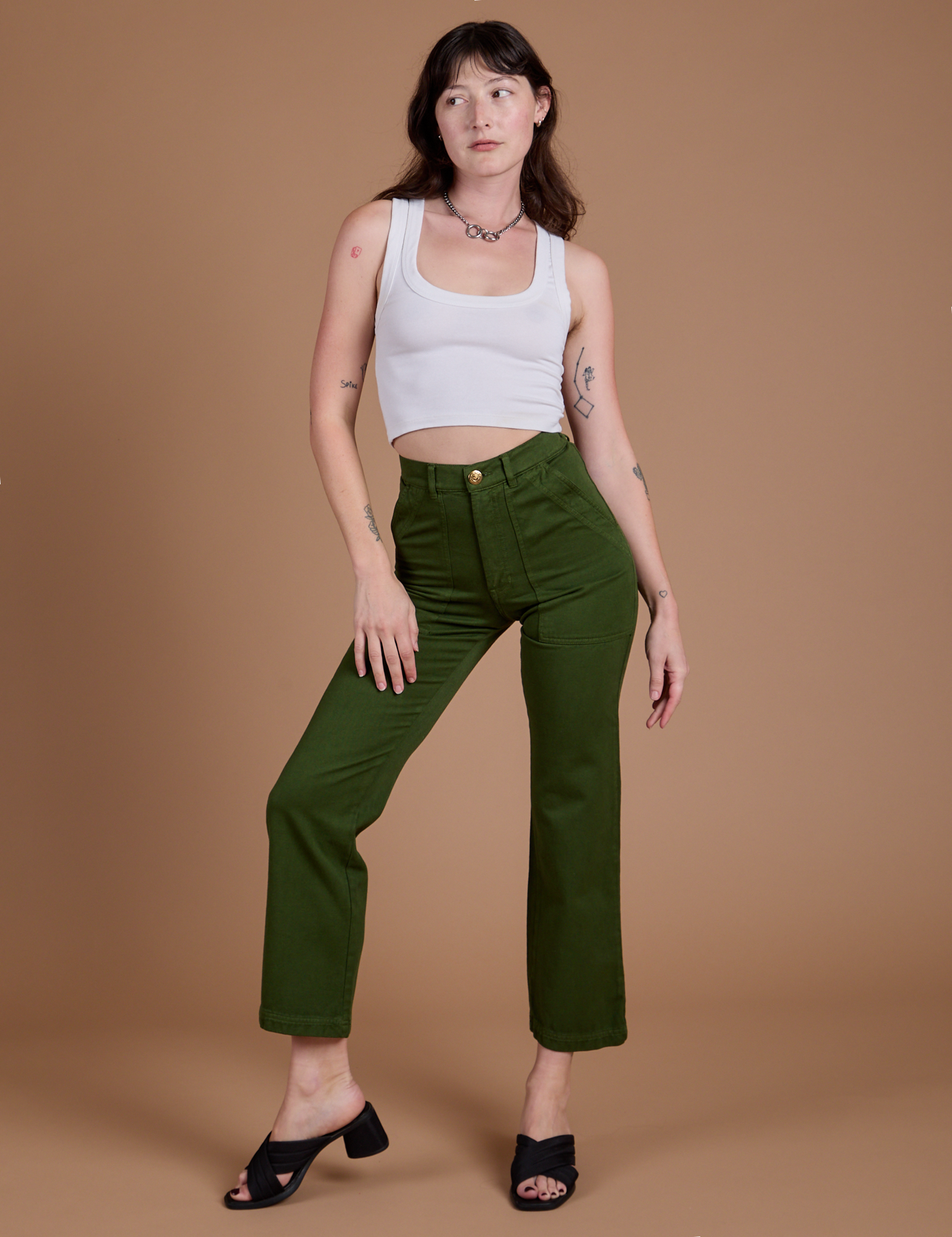 Alex is 5'8" and wearing XXS Organic Work Pants in Evergreen paired with a vintage tee white Cropped Tank