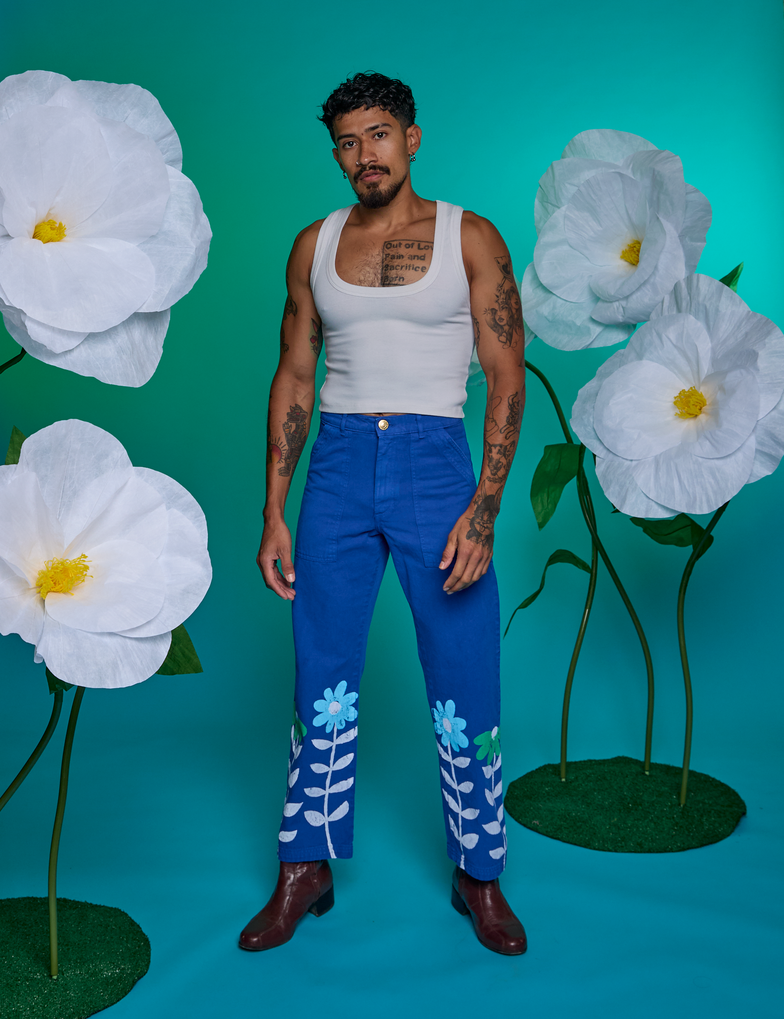 Jesse is 5'8" and wearing XS Paintstamped Work Pants in Daisy paired with a Cropped Tank in Vintage Tee White
