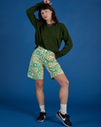 Alex is 5’8” and wearing XXS Longline Work Shorts in Spring Quilt Print paired with evergreen Long Sleeve Burly Tee