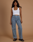 Kandia is 5’3” and wearing XS Railroad Denim Work Pants in Natural paired with vintage tee white Cropped Tank Top