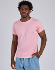Isaac is 5’10” and wearing M Jr. Varsity Tee in Baby Pink