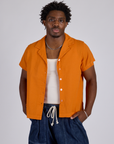 Isaac is 5’10” and wearing M Pantry Button-Up in Creamsicle Orange