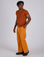 Angled front view of Work Pants in Creamsicle Orange and burnt terracotta Organic Vintage Tee on Isaac