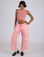 Kira is 5’10” and wearing XS Drop Pocket Cargo Pants in Baby Pink paired with matching Muscle Tee