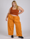 Juliet is 5’7” and wearing 2XL Drop Pocket Cargo Pants in Creamsicle Orange paired with burnt terracotta Cropped Tank