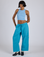 Kira is 5’10” and wearing XS Drop Pocket Cargo Pants in Hawaiian Blue paired with baby blue Racerback Tank