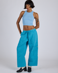 Kira is 5’10” and wearing XS Drop Pocket Cargo Pants in Hawaiian Blue paired with baby blue Racerback Tank