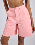 Close up of Longline Work Shorts in Baby Pink on Kira