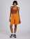 Kira is 5’10” and wearing XS Longline Work Shorts in Creamsicle Orange paired with a burnt terracotta Cropped Tank