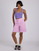 Kira is 5’10” and wearing XS Longline Work Shorts in Lilac Purple paired with a faded grape Cropped Tank