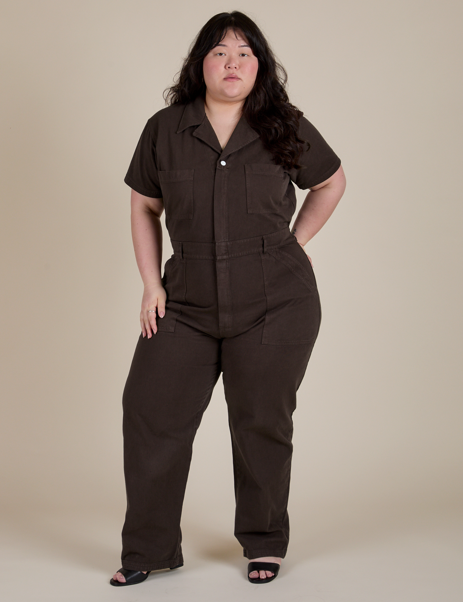 Ashley is 5'7" and wearing 1XL Short Sleeve Jumpsuit in Espresso Brown