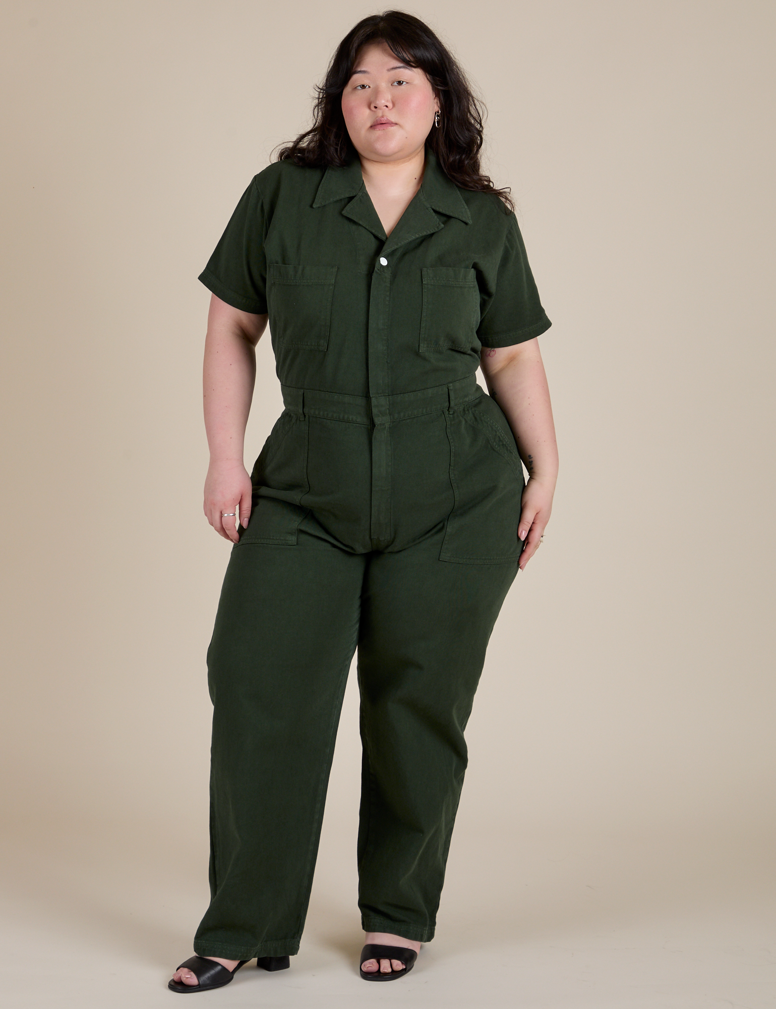 Ashley is 5'7" and wearing 1XL Short Sleeve Jumpsuit in Swamp Green