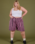 Juliet is 5’7” and wearing 2XL Longline Work Shorts in Bubblegum Pink paired in vintage tee white Cropped Tank