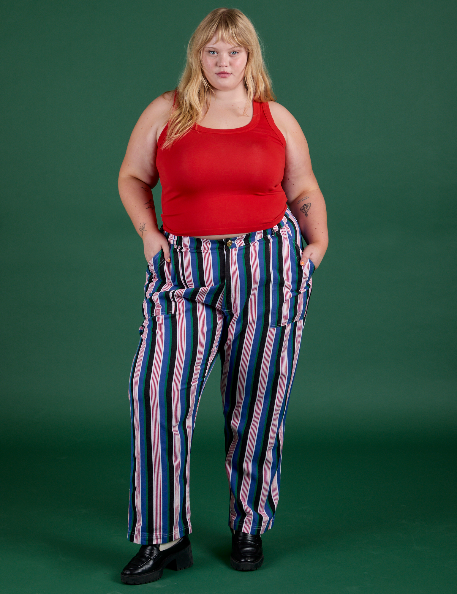 Juliet is 5’7” and wearing 1XL Work Pants in Pacific Stripe paired with mustang red Cropped Tank