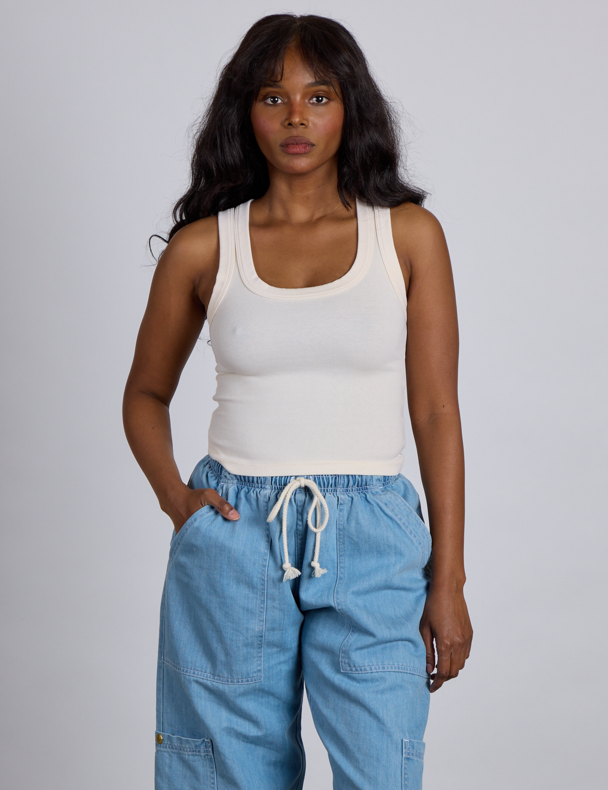 Kandia is 5’4” and wearing P The Tank Top in Vintage Tee Off-White