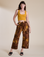 Alex is 5’8” and wearing XXS Magic Waters Drop Pocket Pants in Honey Brown paired with mustard yellow Cropped Tank