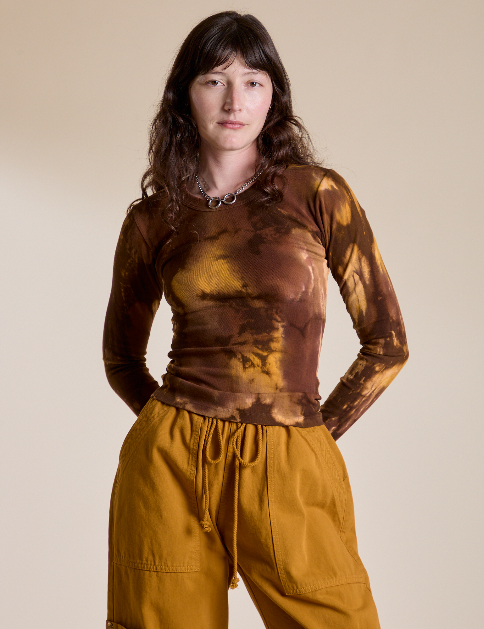 Alex is 5’8” and wearing P Long Sleeve Baby Tee in Honey Brown