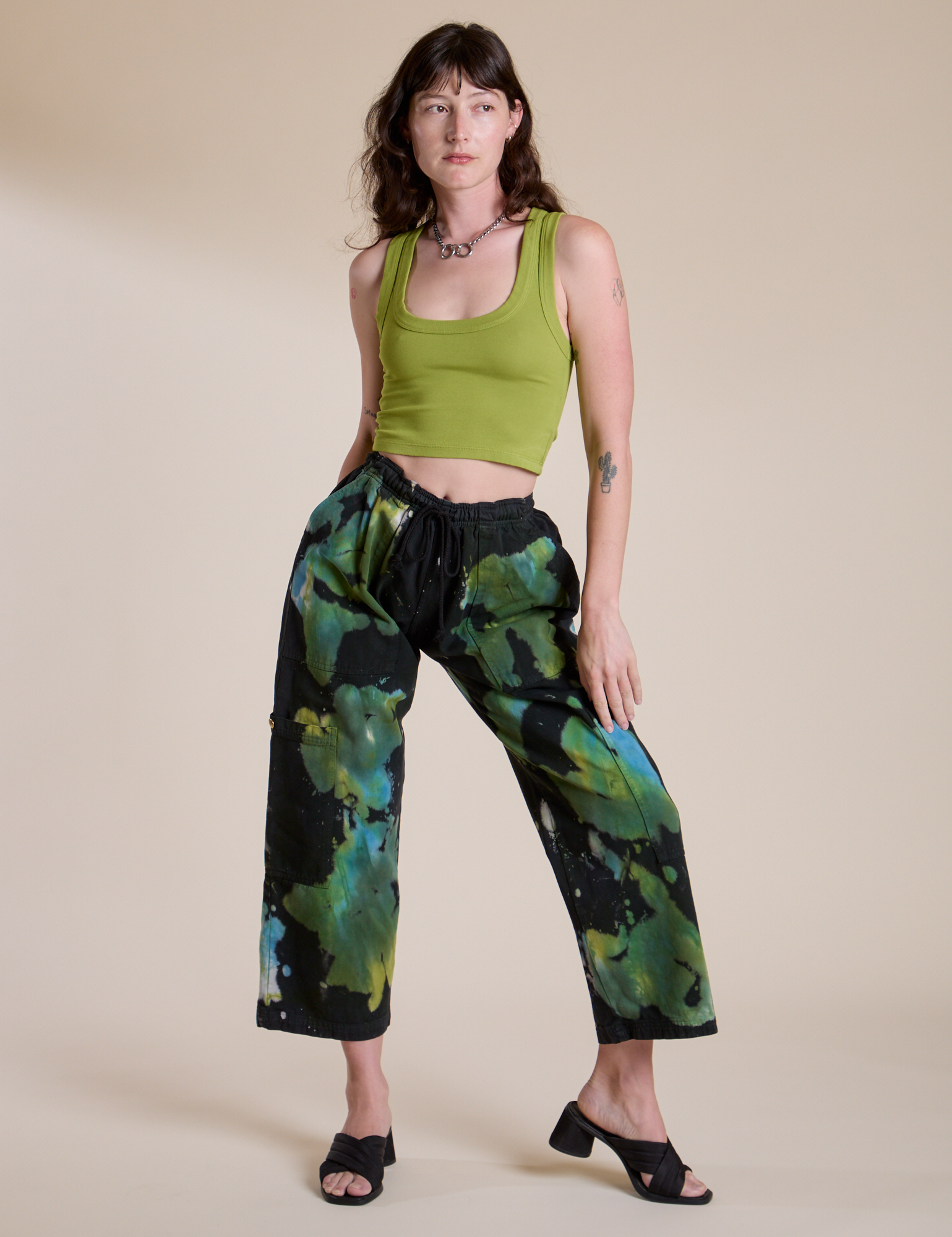 Alex is 5’8” and wearing XXS Magic Waters Drop Pocket Pants in Green Pool paired with gross green Cropped Tank
