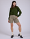 Alex is 5’8” and wearing XXS Pleated Trouser Shorts in Khaki Grey paired with evergreen Long Sleeve Burly Tee