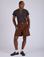 Jerrod is 6’3” and wearing M Pleated Trouser Shorts in Fudgesicle Brown paired with espresso brown Organic Vintage Tee
