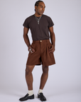 Jerrod is 6’3” and wearing M Pleated Trouser Shorts in Fudgesicle Brown paired with espresso brown Organic Vintage Tee
