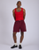 Jerrod is 6’3” and wearing M Pleated Trouser Shorts in Red Wine paired with mustang red Cropped Tank