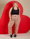 Juliet is 5’7” and wearing 1XL Work Pants in Hot Stuff Print paired with a black Cropped Tank