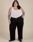 Sam is 5’10” and wearing 4XL Work Pants in Basic Black paired with a Tank Top in Vintage Tee Off-White