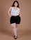 Ashley is 5’7” and wearing 1XL Classic Work Shorts in Basic Black paired with a Cropped Tank in Vintage Tee White