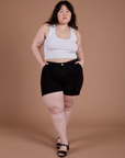 Ashley is 5’7” and wearing 1XL Classic Work Shorts in Basic Black paired with a Cropped Tank in Vintage Tee White