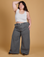 Ashley is 5'7" and wearing 1XL Heritage Wide Leg Trousers in Washed Grey paired with a vintage tee white Cropped Tank