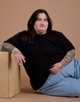 Sam is wearing Burly Tee in Basic Black