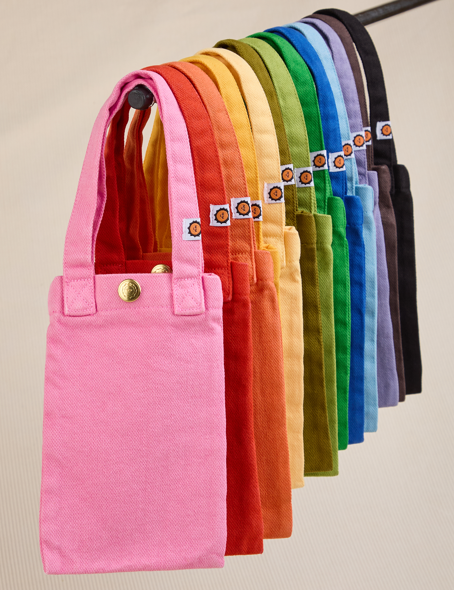 An array of Cell Phone Totes hanging on a rod