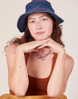 Alex is wearing the Wide Brim Denim Bucket Hat in dark wash