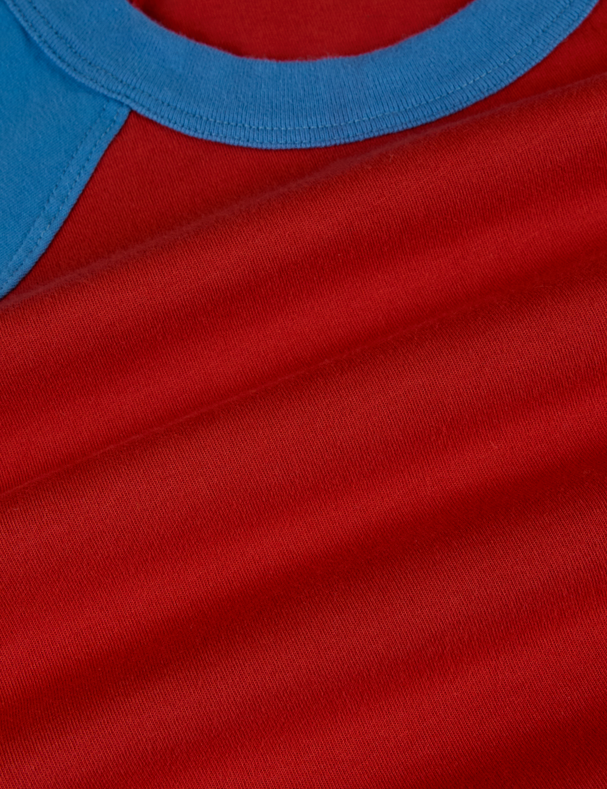 Fabric close up of the Mustang Red/Blue Colorblock Raglan Tee
