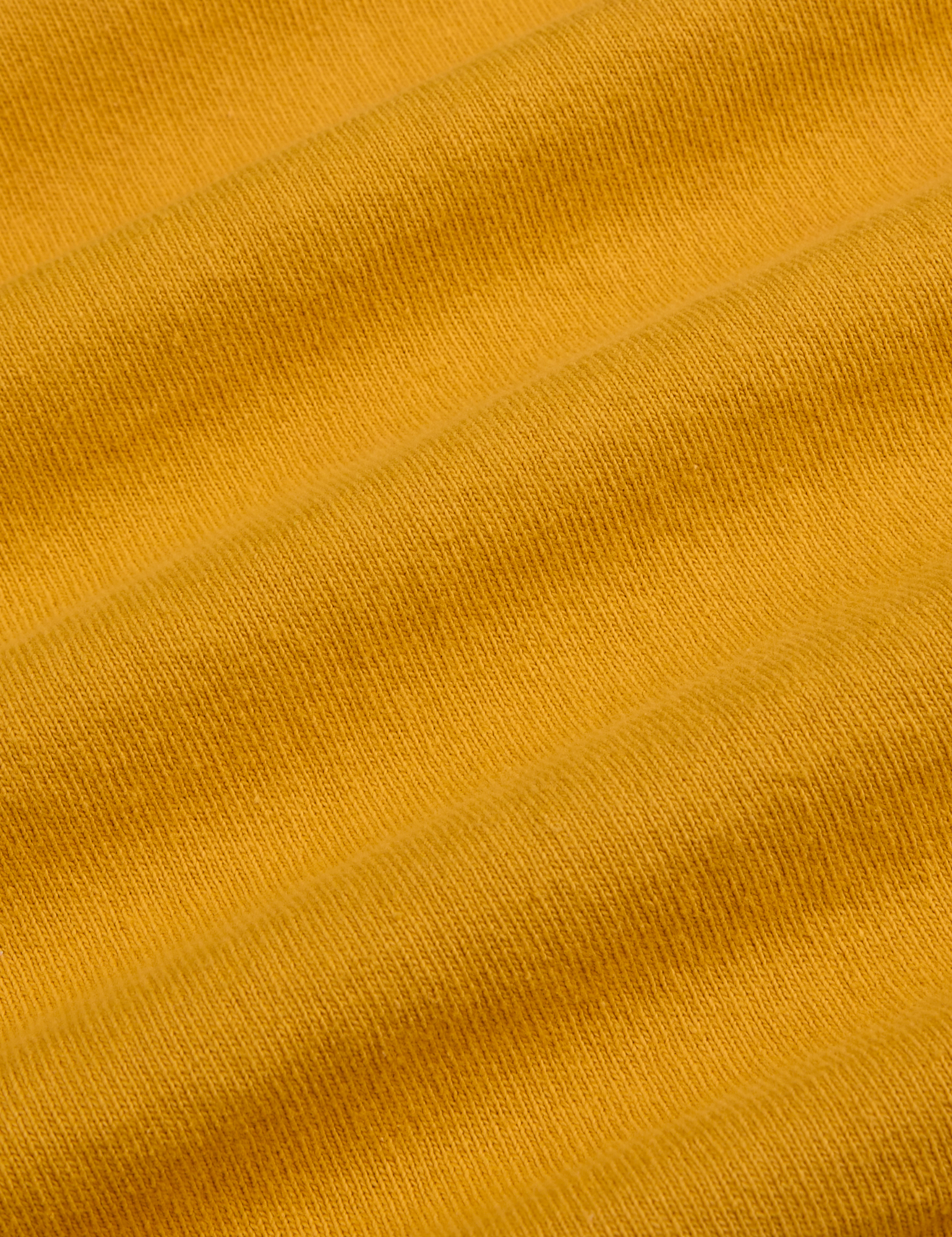 Painted Burly Tee in Mustard Yellow fabric detail close up