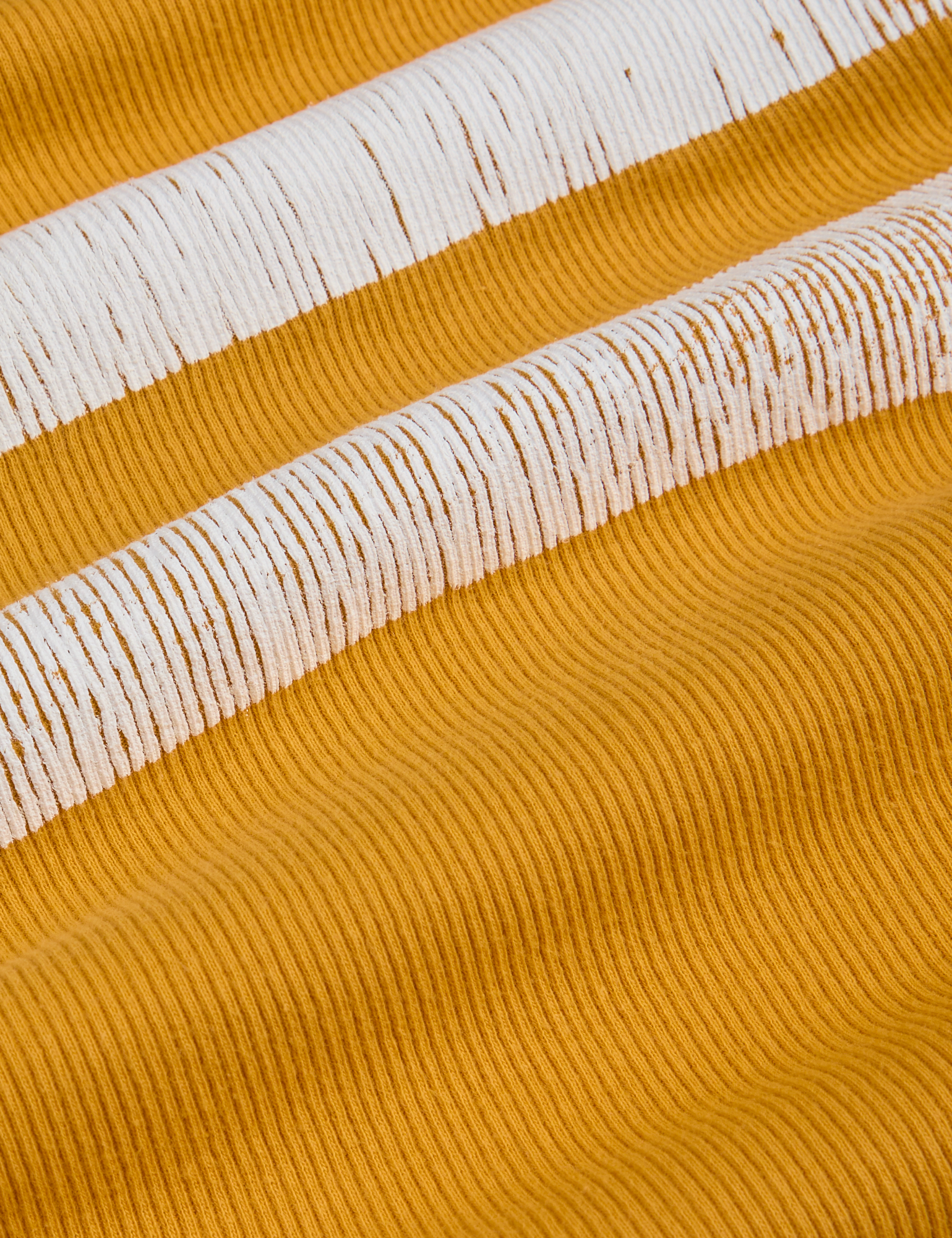Painted Muscle Tee in Mustard Yellow fabric detail close up with white painted stripe 