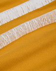 Painted Muscle Tee in Mustard Yellow fabric detail close up with white painted stripe 